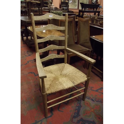 330 - An oak ribbon-back armchair having basket weave seat and on turned supports.