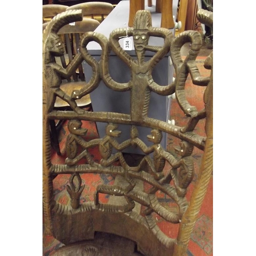 334 - West African Malawi perpendicular chair, having carved figural decoration.