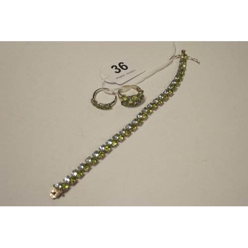 36 - Silver sky blue topaz and peridot bracelet, and two rings to match.