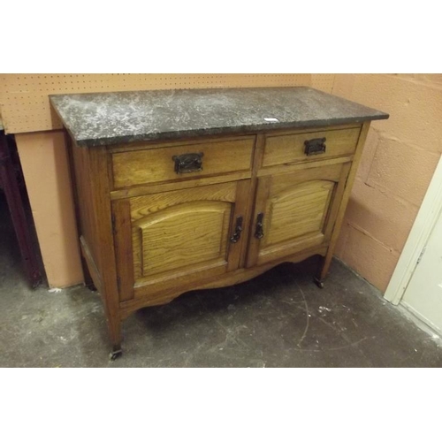 401 - Marble topped oak washstand having two short drawers and pair of panel cupboard doors set on tapered... 