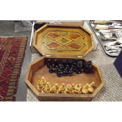 46 - Parquetry inlaid box containing a 32-piece carved wood chess set.