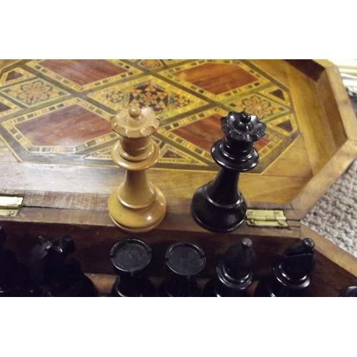 46 - Parquetry inlaid box containing a 32-piece carved wood chess set.