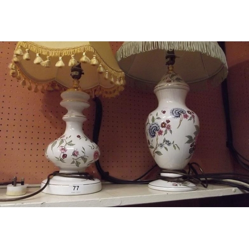 77 - Two floral ceramic table lamps with fringed shades.