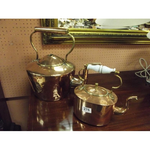 276 - Large antique copper kettle, and an oval copper kettle. (2)