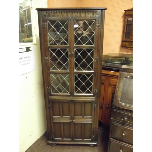 291 - Reproduction oak leaded glazed corner cupboard, 66 in. high.