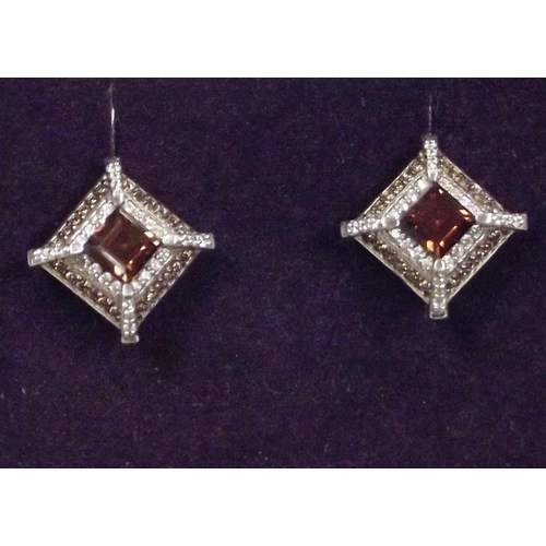 31 - Pair of Art Deco silver earrings, set with amber stones.