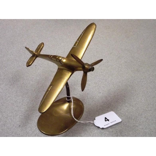 4 - Cast brass model of a Spitfire, on stand, 5 in. high.