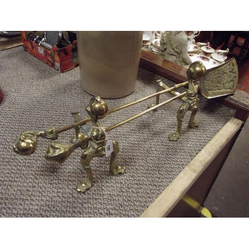 40 - A cast brass fire shovel and poker, with claw and ball handles, with pair of matching andirons.