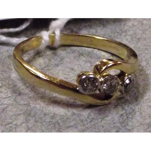 48 - 18 ct. yellow gold crossover ring with three collet set diamonds, approximately 0.30 ct. total, size... 