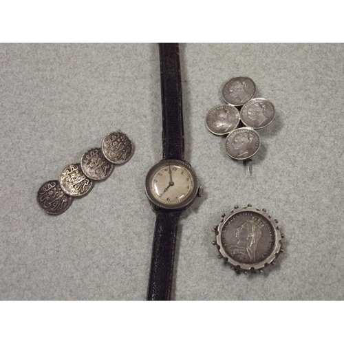7 - Vintage silver cased ladies wristwatch, and three Victorian silver coin brooches.