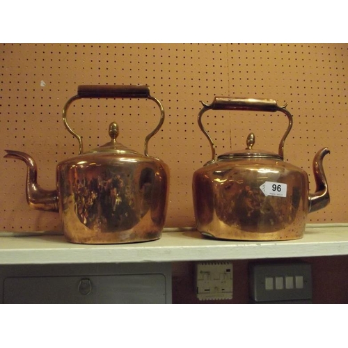 96 - Antique circular copper kettle with cover, and an antique oval copper kettle with cover.