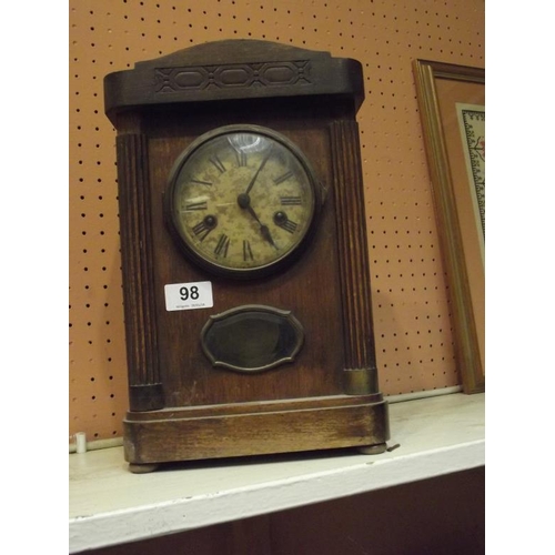 98 - German mantle clock with visible pendulum.