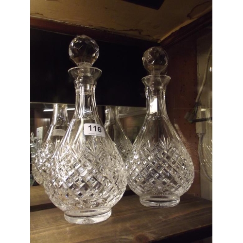 116 - Pair of circular cut glass decanters with stoppers.