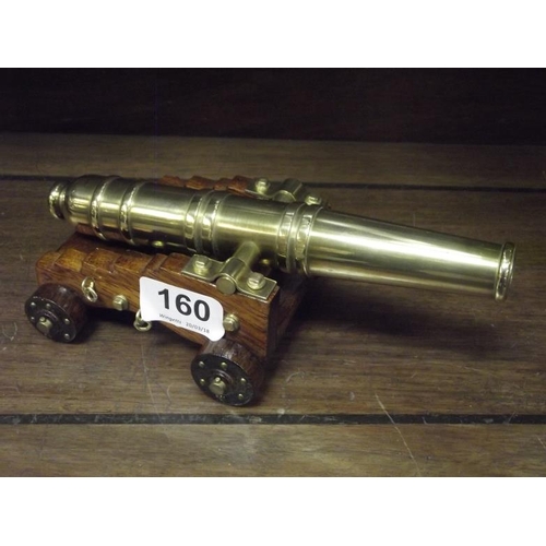 160 - Model brass cannon on wooden carriage, 8 in. long.