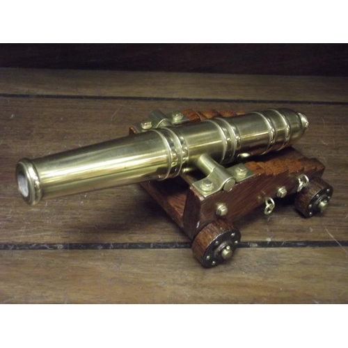 160 - Model brass cannon on wooden carriage, 8 in. long.