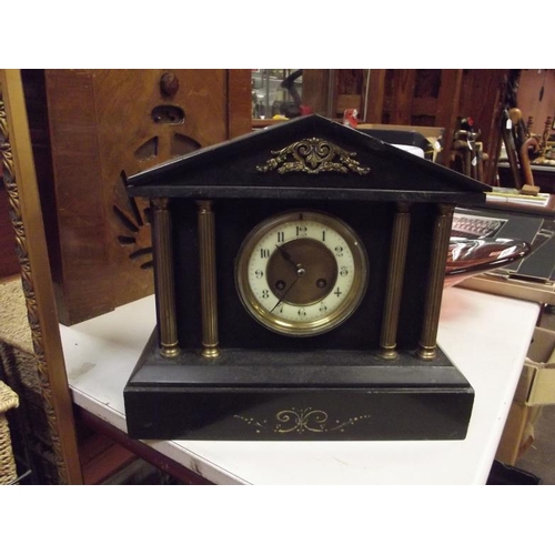 181 - Polished black slate mantle clock of architectural design.