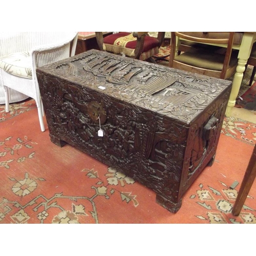 265 - Camphorwood chest having lift-up lid and heavily carved decoration, 22 in. x 41 in. x 20 in. deep.