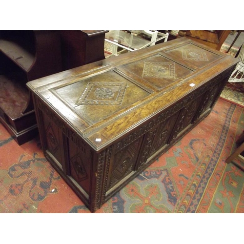 284 - Antique oak coffer, the lift-up panel top over further carved panels and on stile supports, 23 in. x... 