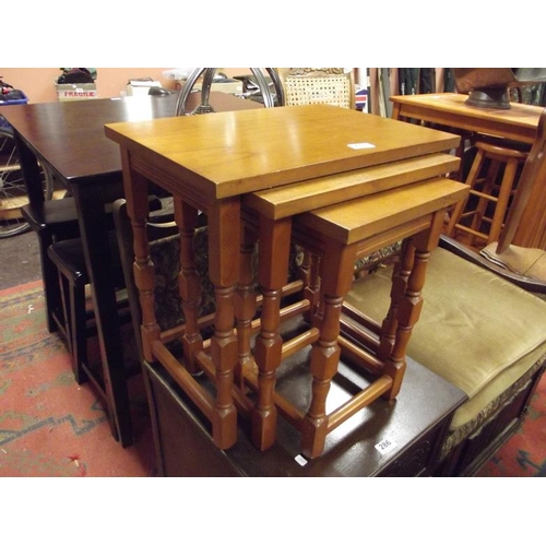 285 - Modern nest of three tables set on turned supports, the tallest 18.5 in. high.