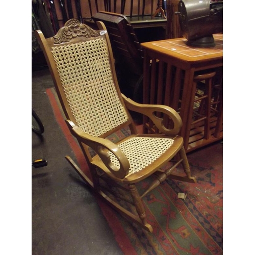 290 - Beech framed rocking chair having cane back and seat.