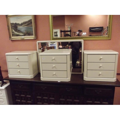 315 - Three modern three-drawer bedside chests, and a dressing mirror. (4)