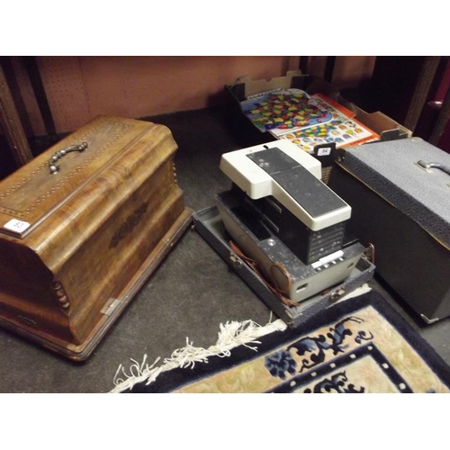 83 - Vintage sewing machine in inlaid case and a vintage projector.