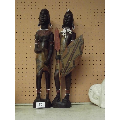 70 - Two carved wood native figures.