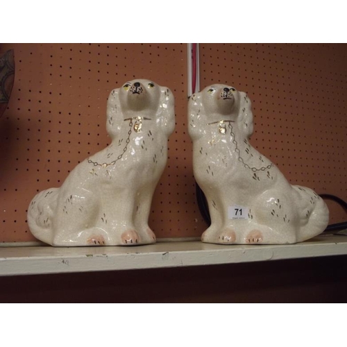 71 - Two Staffordshire seated spaniels.