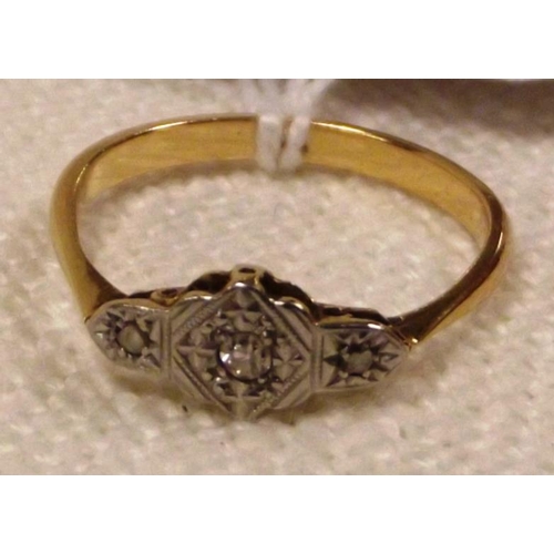 11 - 18 ct. yellow and white metal ring set with three small diamonds, size Q, 2.3 g.