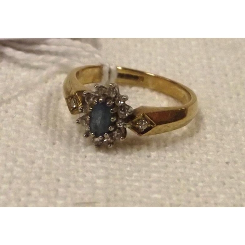 115 - 9 ct. yellow gold ring set with a clear blue stone surrounded by small diamonds, size L, 2.7 g.