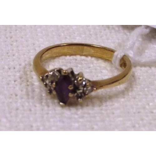 117 - 9 ct. yellow gold ring set with a small amethyst flanked by small diamonds, size L, 1.9 g.