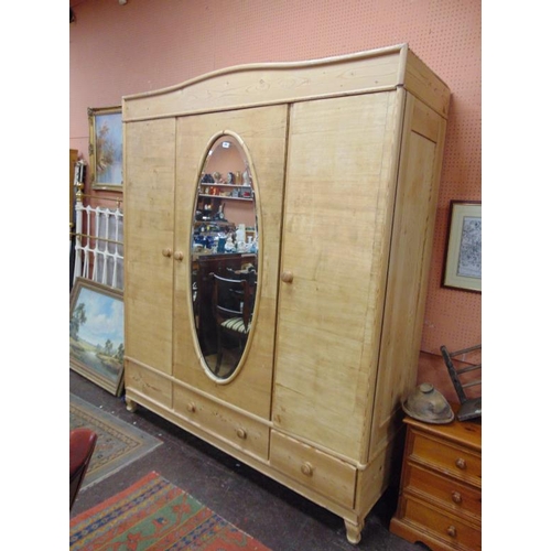 304 - Continental pine wardrobe, centre mirror flanked by two doors  and three drawers to base, 84 x 71 x ... 