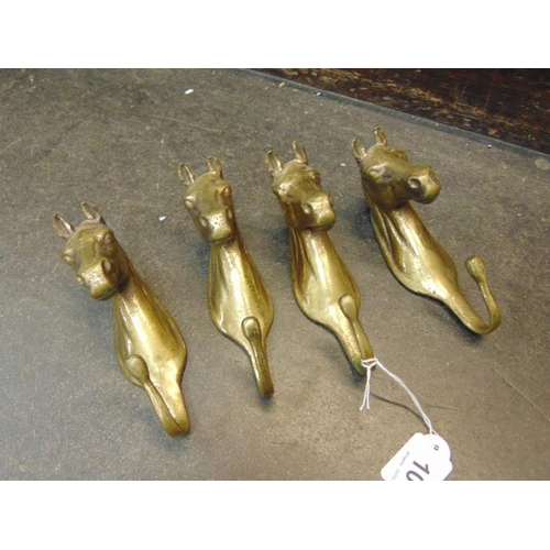 108 - Four brass horse head coat hooks.