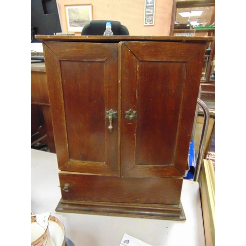 119 - An oak double door smoker's cabinet.