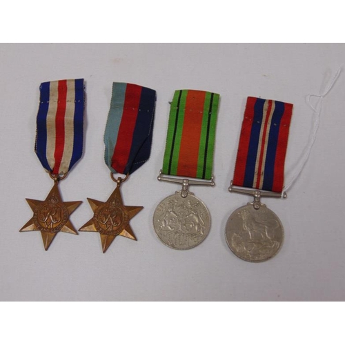 14 - Group of four World War II medals with ribbons.