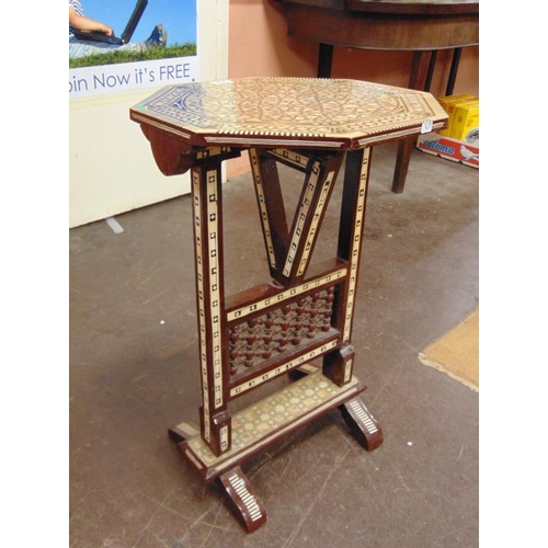 206 - Moorish style folding table on stand having inlaid decoration. 33