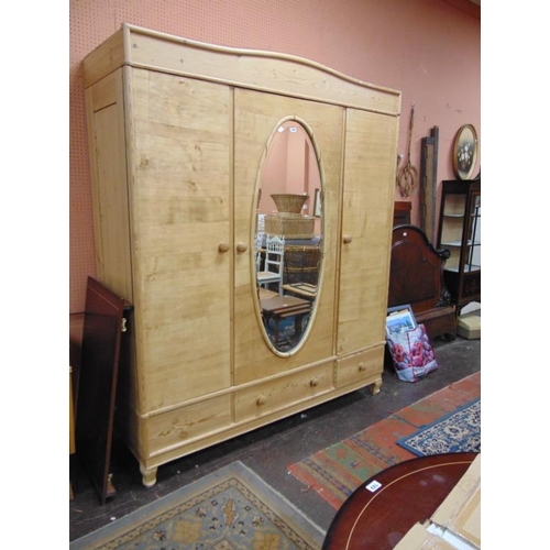 304 - Continental pine wardrobe, centre mirror flanked by two doors  and three drawers to base, 84 x 71 x ... 