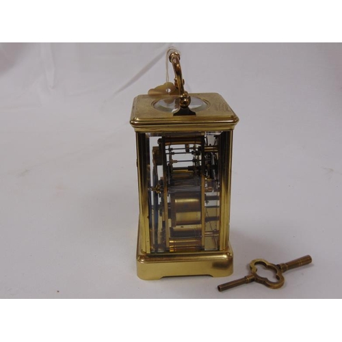 24 - French gilt brass cased carriage clock, 8 day movement striking on a gong, 55 in. high.