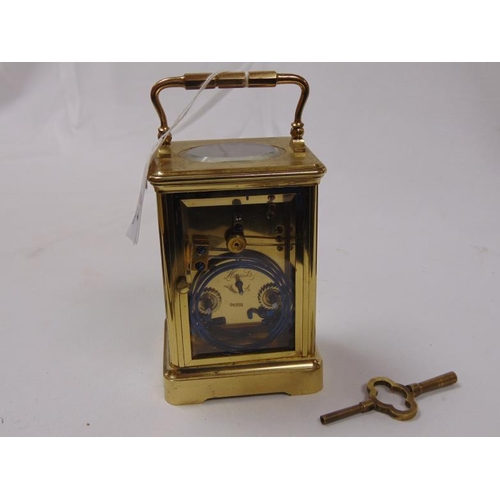 24 - French gilt brass cased carriage clock, 8 day movement striking on a gong, 55 in. high.