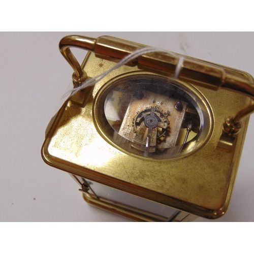 24 - French gilt brass cased carriage clock, 8 day movement striking on a gong, 55 in. high.