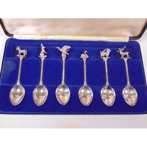 223 - Cased set of seven animal mounted plated spoons.