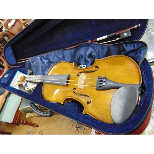 239 - Cased modern violin and bow.