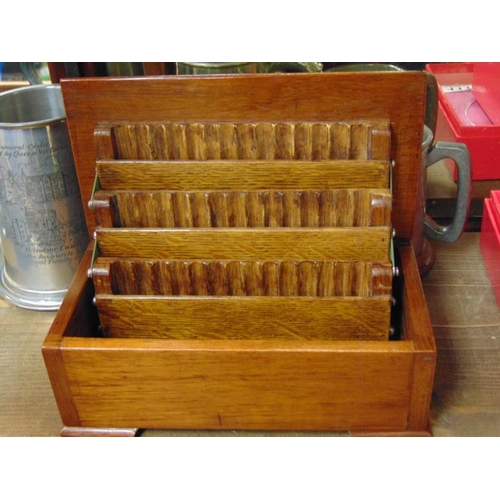 112 - Burr oak cigarette box with fitted interior and three pewter tankards.