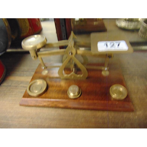 127 - Brass postal scales with weights.