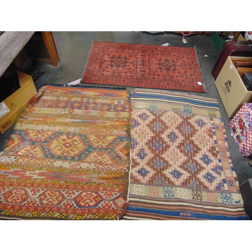 13 - Three small antique Persian rugs.