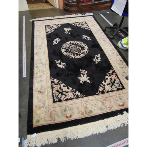 14 - Chinese black/cream grand floral rug.