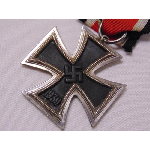 26 - World War Two German Iron Cross, Second Class, maker J.E. Hammer & Sohne, with ribbon.