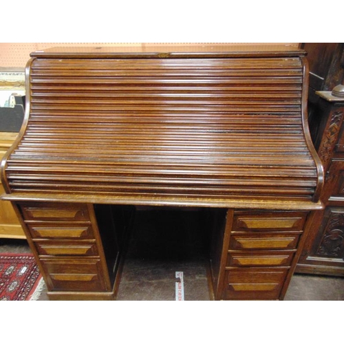 322 - Cutler, large oak roll top desk, tambour front revealing a fitted interior with drawers to either si... 