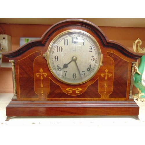 33 - Inlaid mahogany cased dome top mantel clock, 8 day movement striking on a gong, 11 in. high