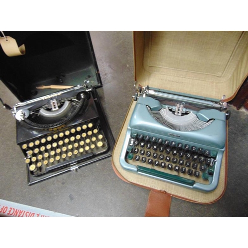 52 - Two vintage portable typewriters in cases.